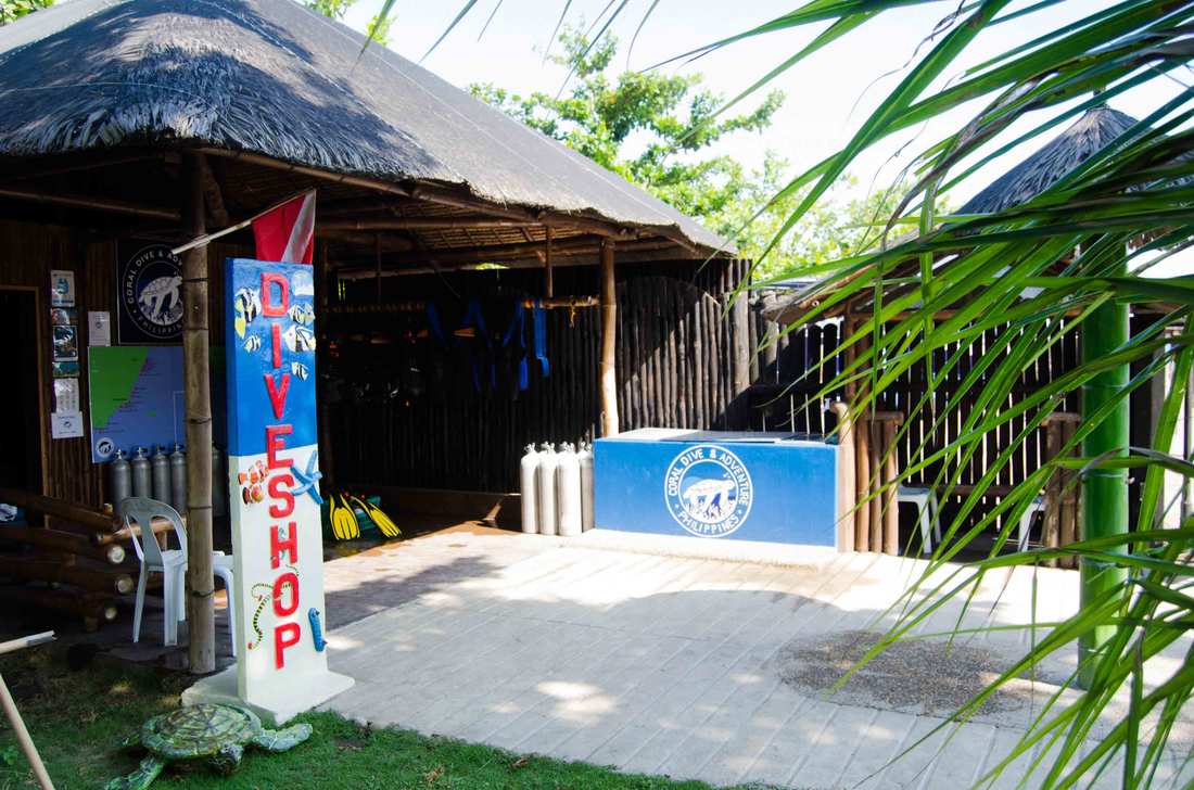 Scuba buoyancy jackets hanging on a timber pole at the dive shop